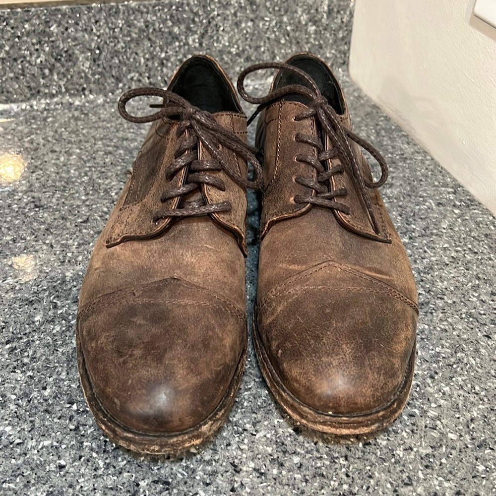 Frye distressed modern wingtip shoes.